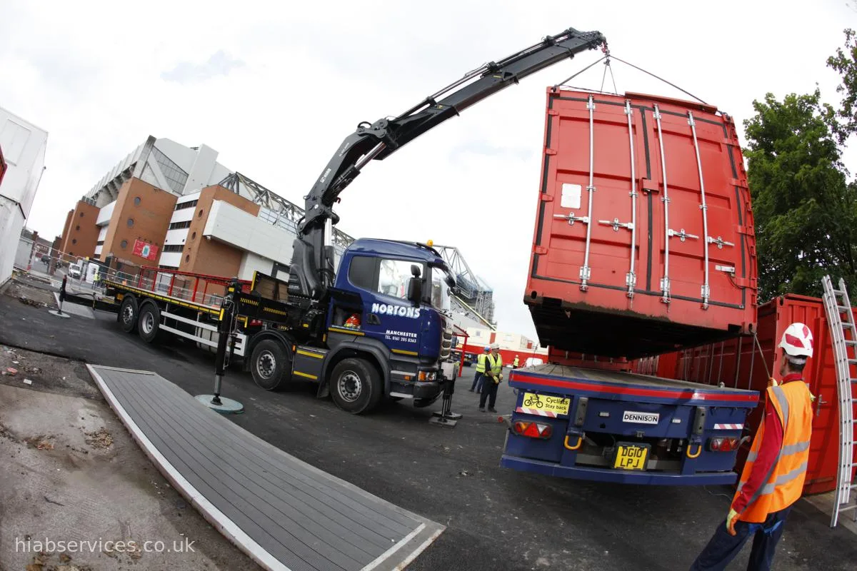 HIAB 855 crane lifting a shipping container
