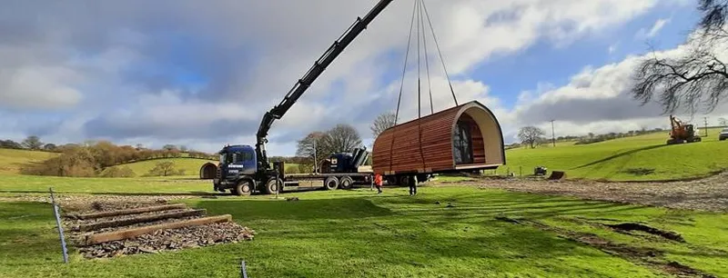 Crane lifting glamping pods