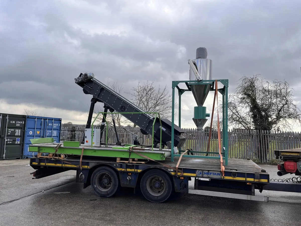 HIAB crane truck lifting heavy machinery for transport UK