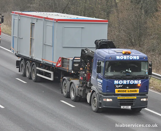 HIAB wide load transport moving an oversized collection from port to site
