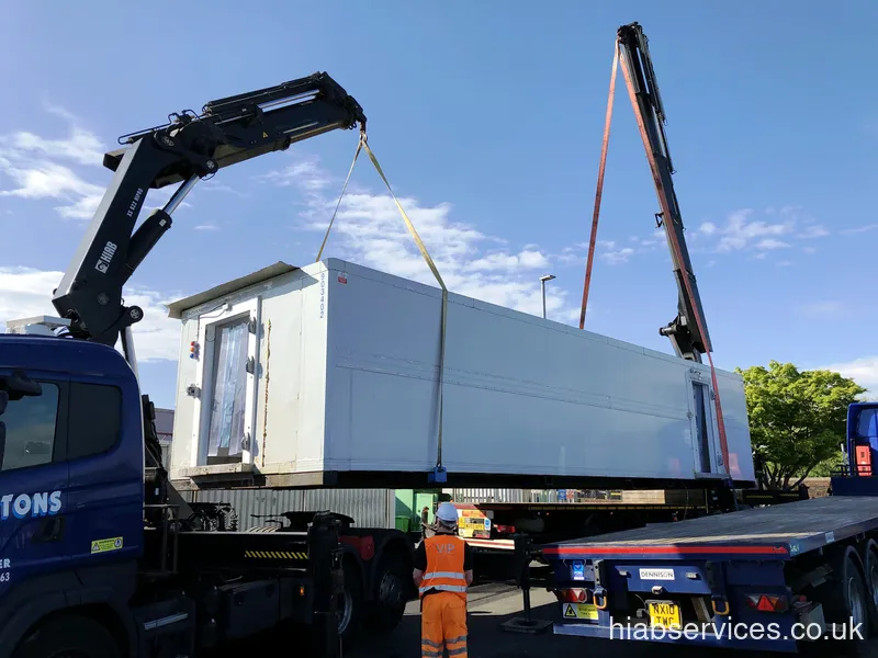 Smaller HIAB lifting a panel into position UK